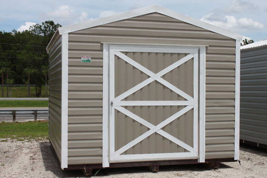 Tan aluminum shed with white trim, ready for delivery