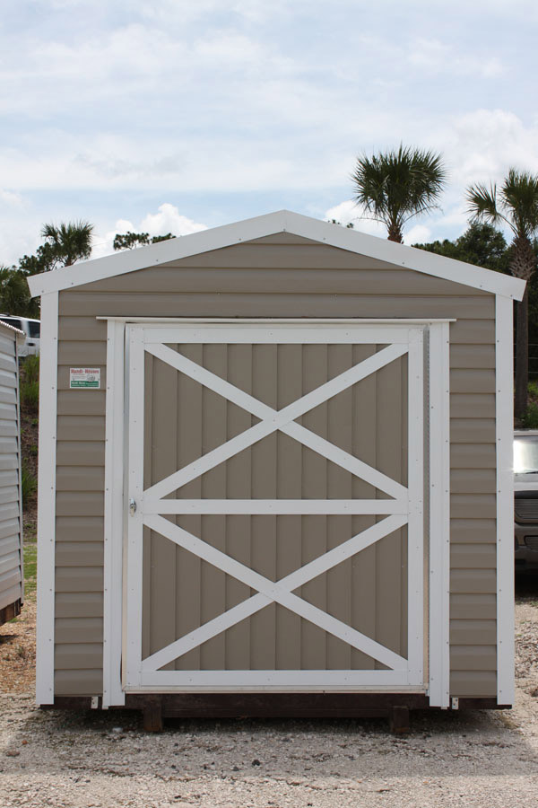 Front view of a tan aluminum storage shed at the DeLand yard